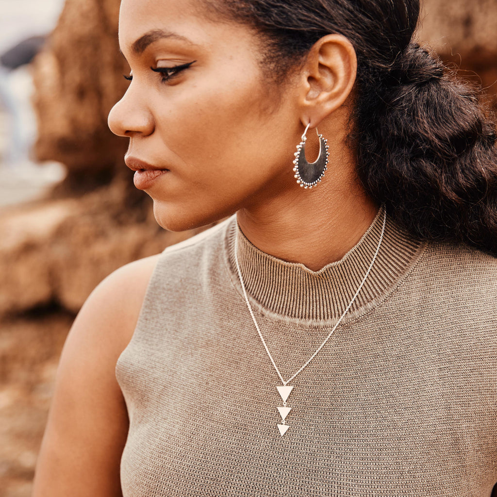 modelo con pendientes aro Nara y collar Nai